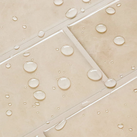 Close-up of beige tiles with water droplets on a tiled floor