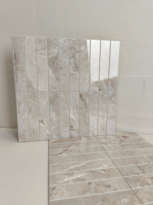 Tile sample with a beige and brown marble-like pattern on a white background