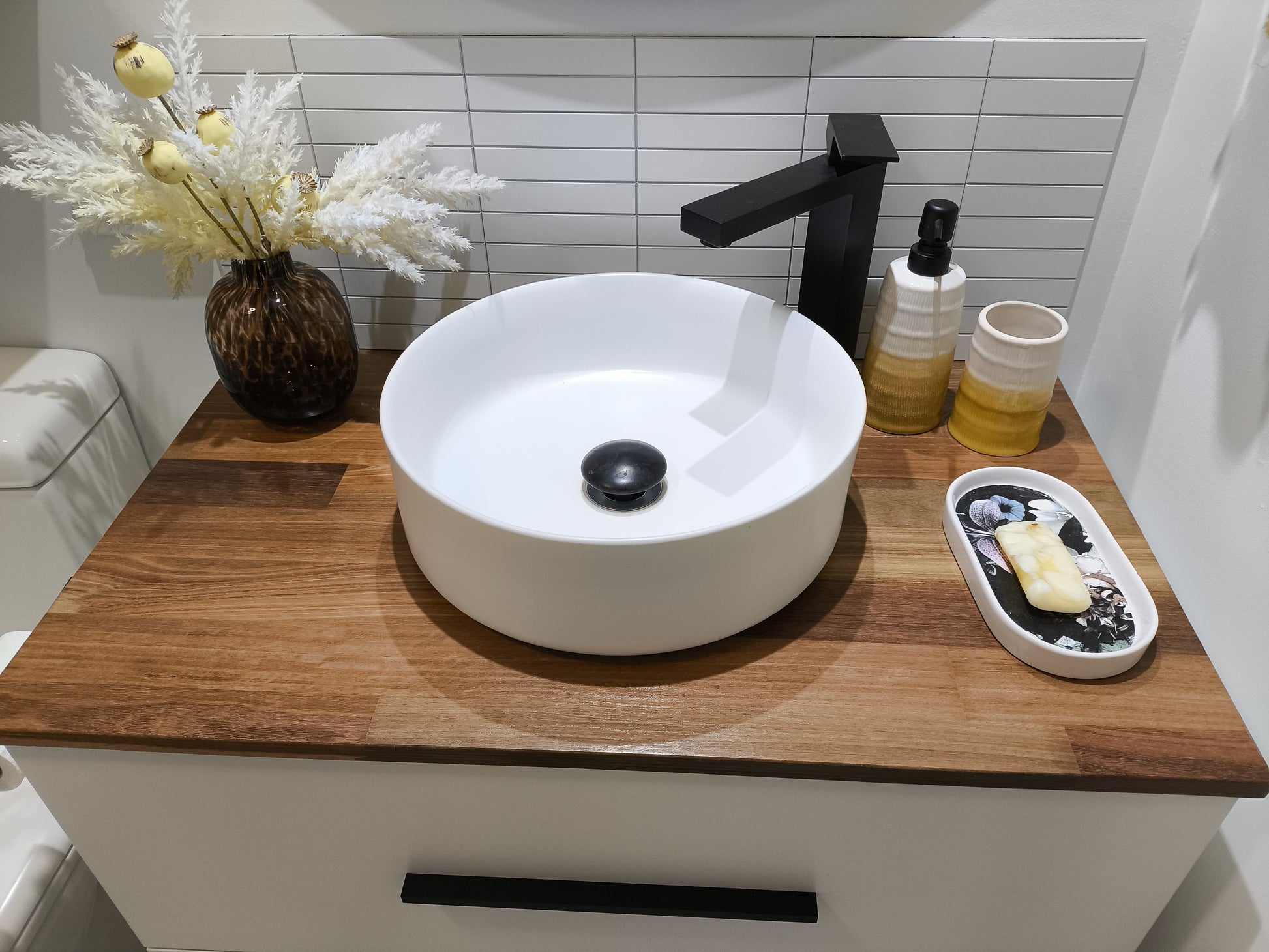 Bathroom vanity with Matte White Kit Kat Stick on Composite Tiles as a backsplash, enhancing the space with a stylish, contemporary look.
