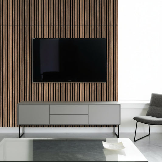 Modern living room with a wooden TV stand, black TV, and red chair.