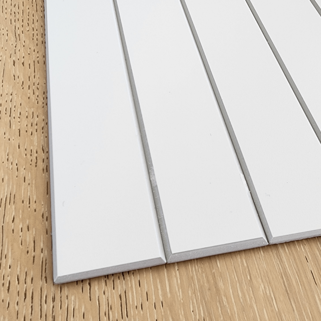 Close-up of Kit Kat Stick on Composite Tile in Matte White, showcasing its smooth surface and easy-to-install adhesive backing.