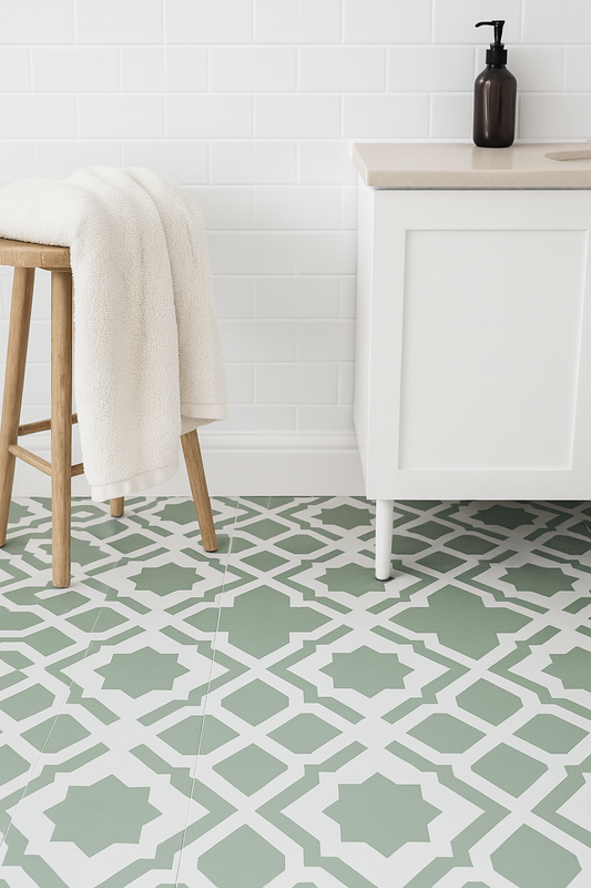 Bathroom with patterned green and white tiles, wooden stool, and white cabinet.