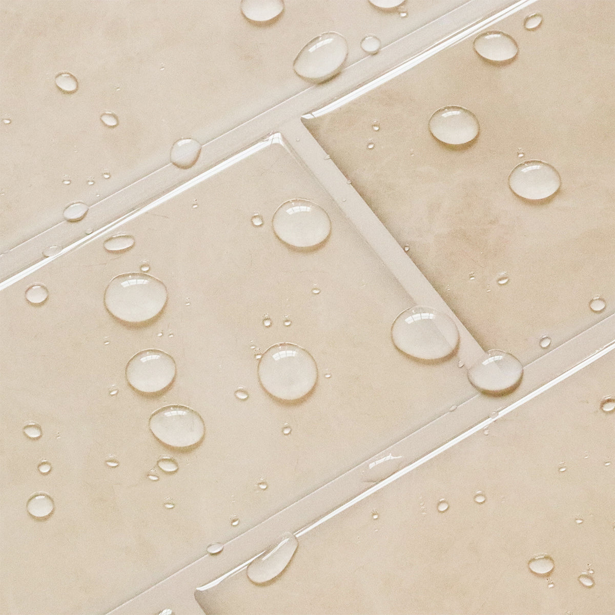 Close-up of beige tiles with water droplets on a tiled floor