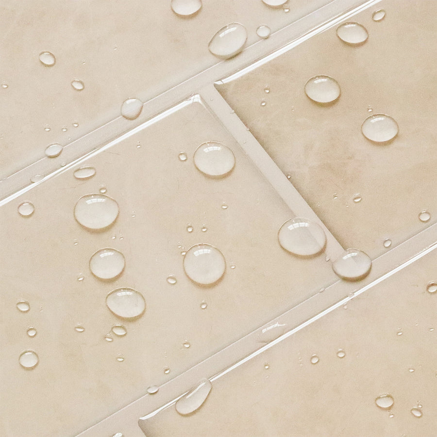 Close-up of beige tiles with water droplets on a tiled floor