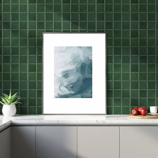 Framed abstract art on a green tiled wall above a wooden cabinet.