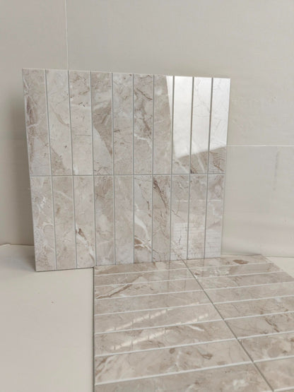 Tile sample with a beige and brown marble-like pattern on a white background