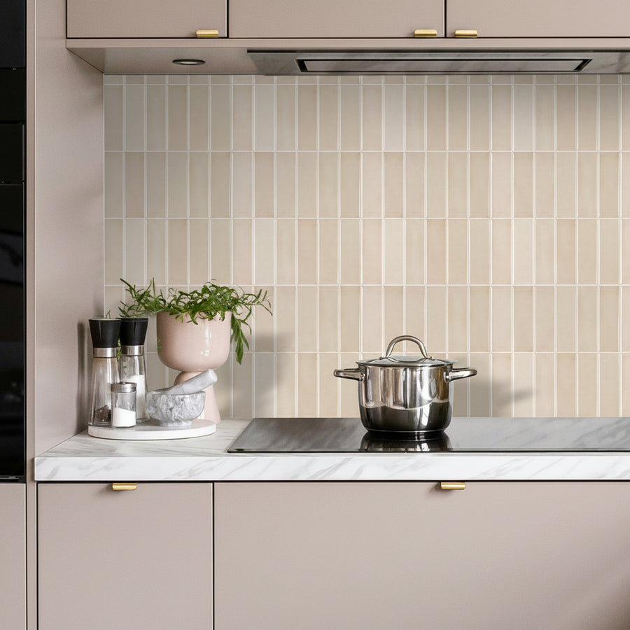 Modern kitchen with tiled backsplash, countertop items, and neutral cabinets.