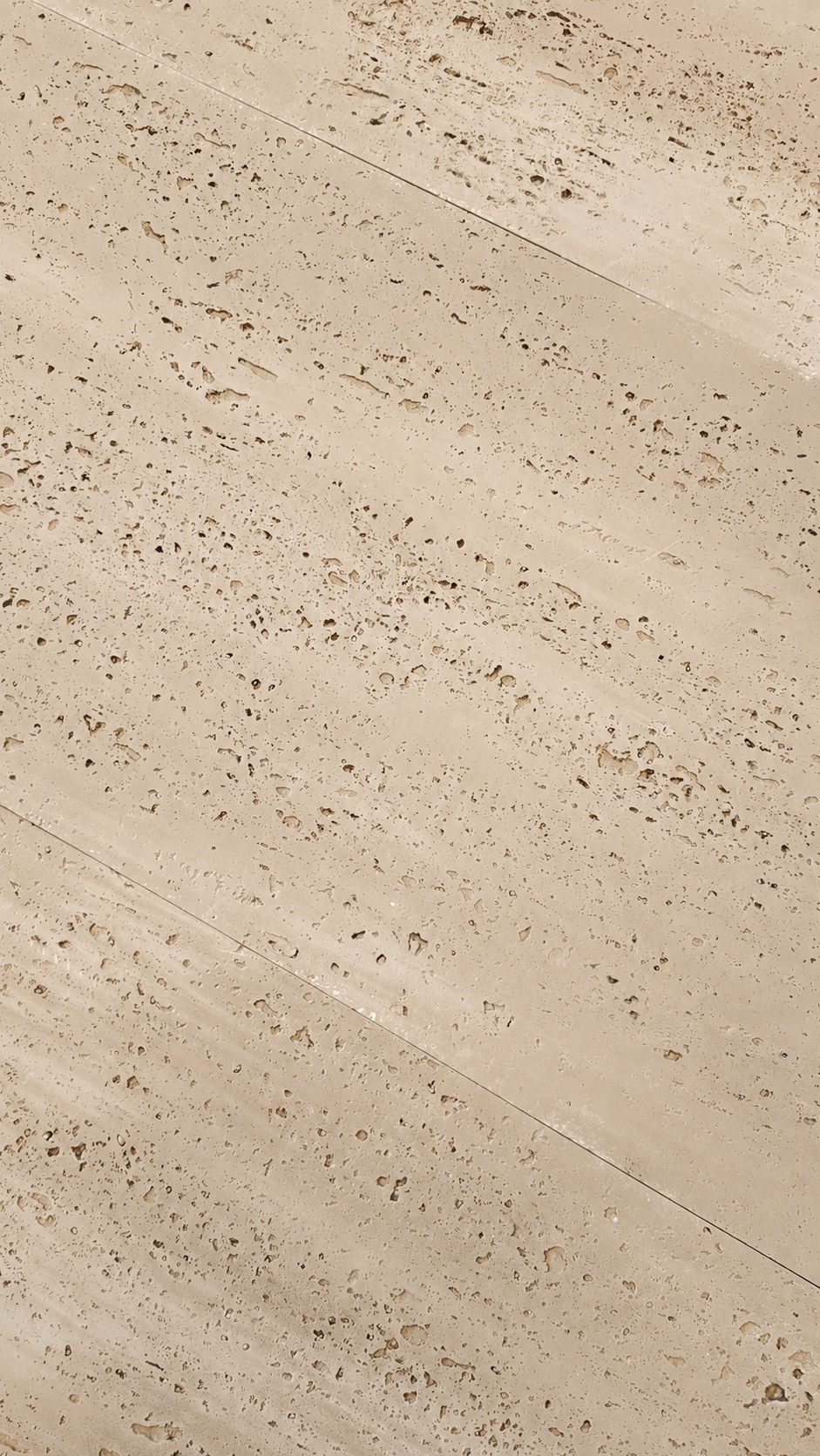 Beige travertine stone tile with natural porous texture and diagonal seams.