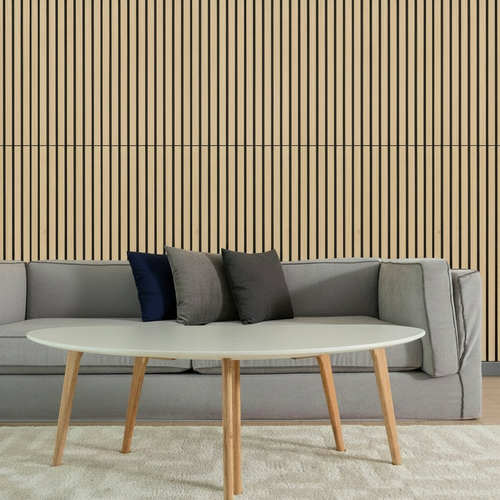 Gray sofa with colorful cushions and a white coffee table in front of a striped wall.